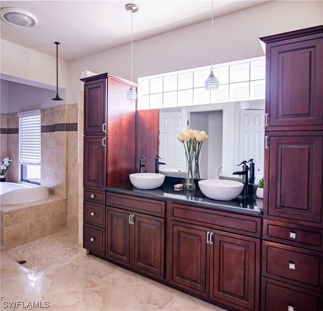 bathroom with vanity and a tile shower