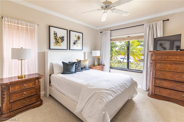 carpeted bedroom with crown molding and ceiling fan