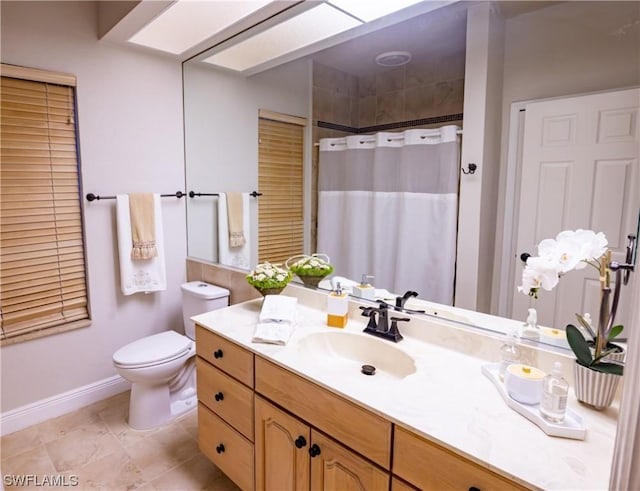 bathroom with vanity, toilet, and walk in shower