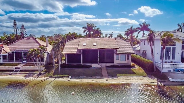 back of property featuring a water view