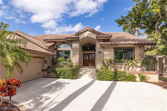 mediterranean / spanish house with a garage