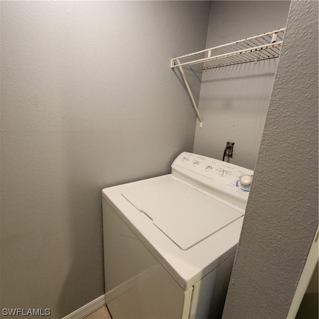 clothes washing area featuring washer / dryer and laundry area