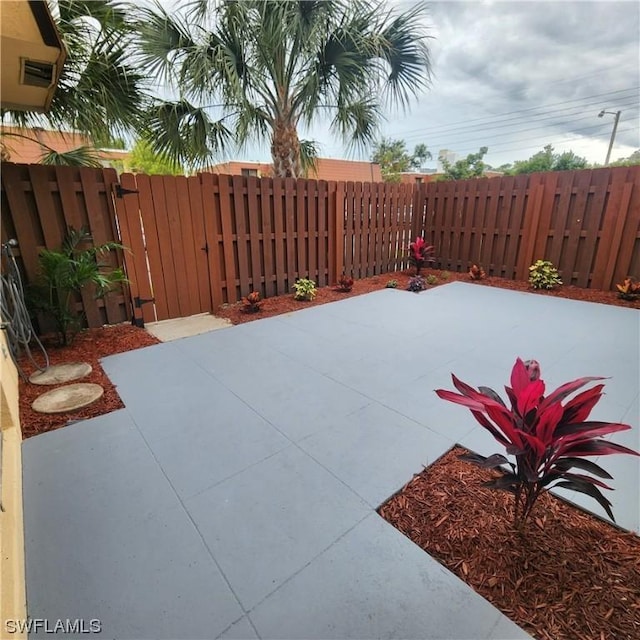 view of patio featuring a gate and fence