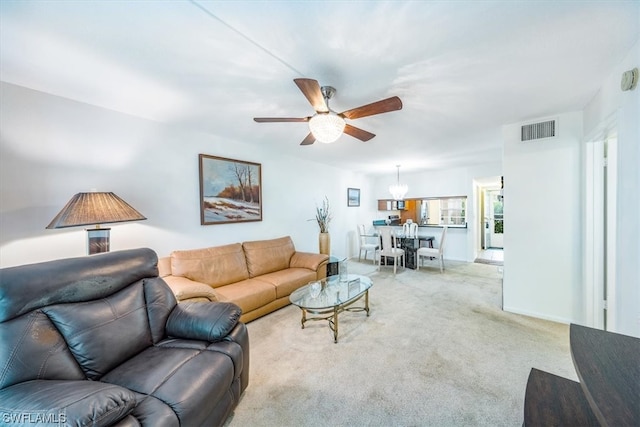 carpeted living room with ceiling fan