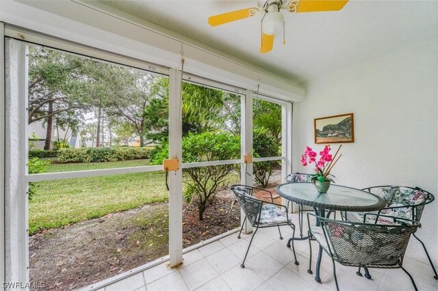 sunroom featuring ceiling fan