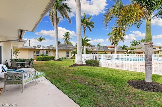 view of yard with a community pool and a patio area