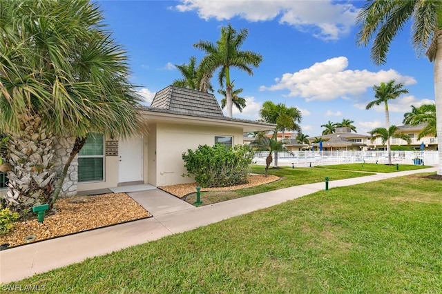 view of property's community with a lawn