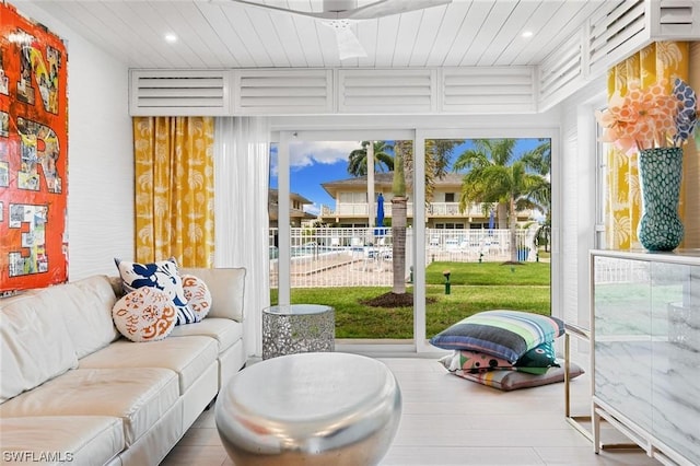 sunroom / solarium featuring wood ceiling and plenty of natural light