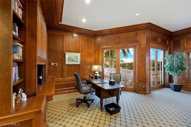 carpeted office space featuring wood walls and crown molding