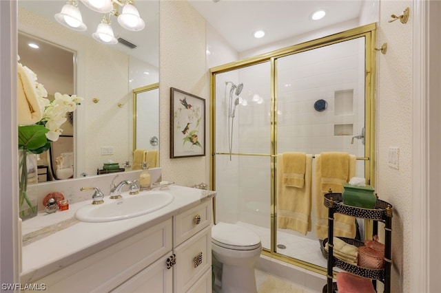 bathroom with visible vents, toilet, vanity, a shower stall, and recessed lighting