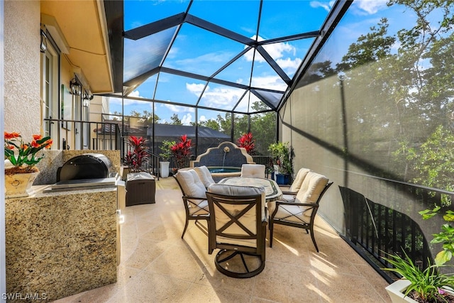 view of patio / terrace featuring a lanai