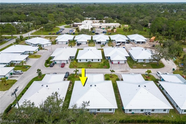 drone / aerial view with a forest view and a residential view