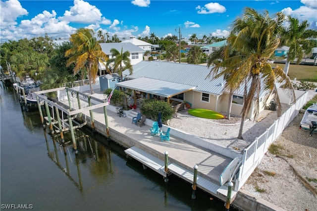 dock area with a patio and a water view