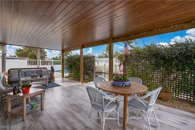 wooden terrace with a patio