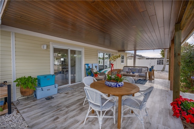 wooden deck with a patio area and an outdoor living space