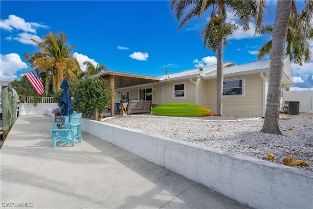 view of front of property with cooling unit and a patio