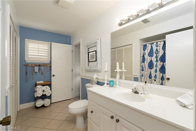 bathroom with vanity, toilet, and tile patterned flooring