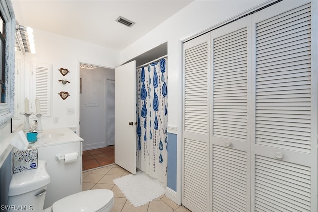 bathroom with vanity, toilet, tile patterned floors, and a shower with curtain