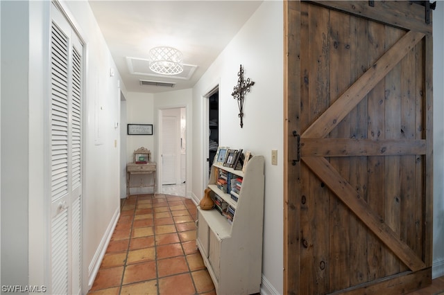 hall featuring a barn door