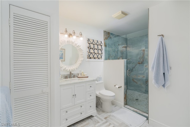 bathroom featuring vanity, walk in shower, and toilet