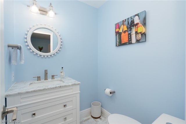 bathroom featuring toilet and vanity