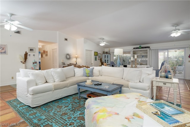 tiled living room with ceiling fan and vaulted ceiling