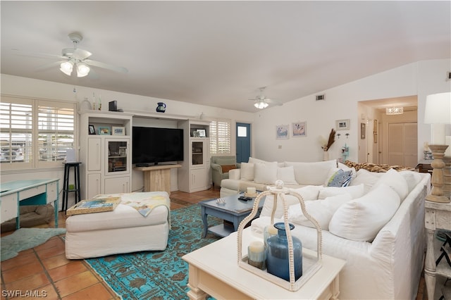 living room with ceiling fan, a healthy amount of sunlight, and vaulted ceiling