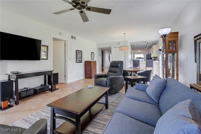 living room with ceiling fan and light tile patterned floors