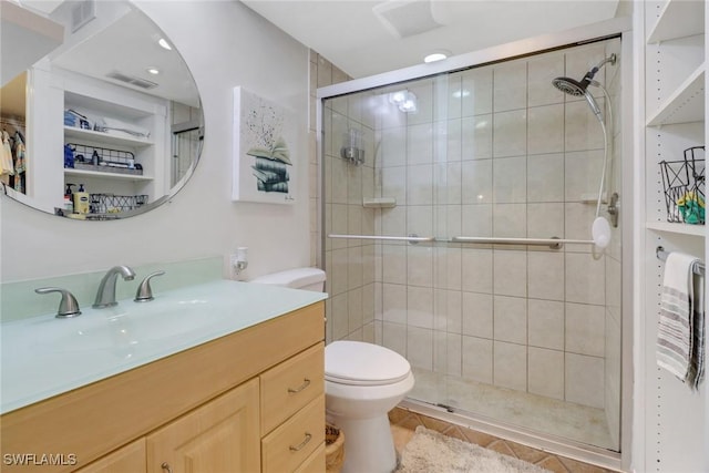 bathroom featuring tile patterned flooring, vanity, an enclosed shower, and toilet