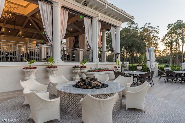 patio terrace at dusk with a gazebo and an outdoor fire pit