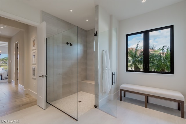 bathroom featuring a shower with shower door