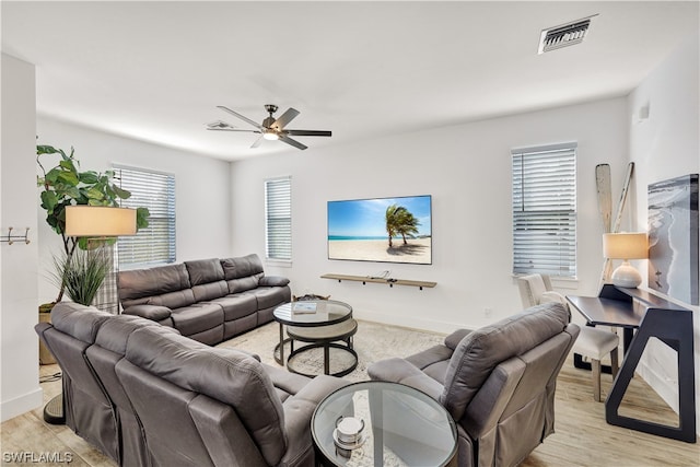 living room featuring ceiling fan and light hardwood / wood-style flooring