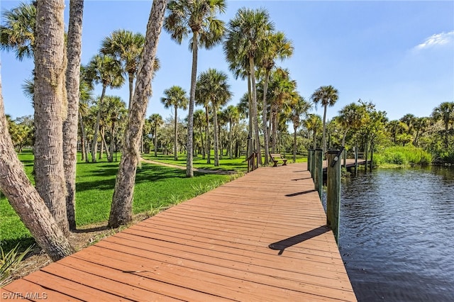 dock area featuring a water view and a lawn