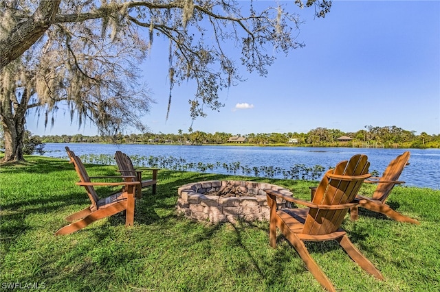 exterior space featuring a water view and a fire pit