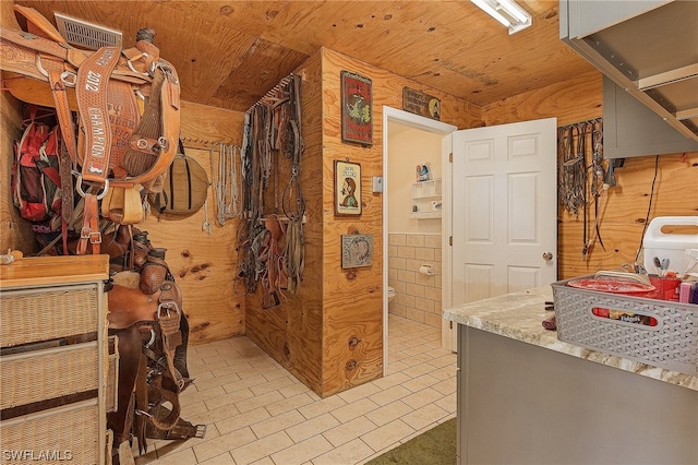 bathroom featuring wood ceiling, wood walls, and tile flooring