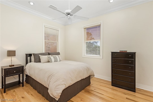 bedroom with light hardwood / wood-style flooring, ceiling fan, and crown molding