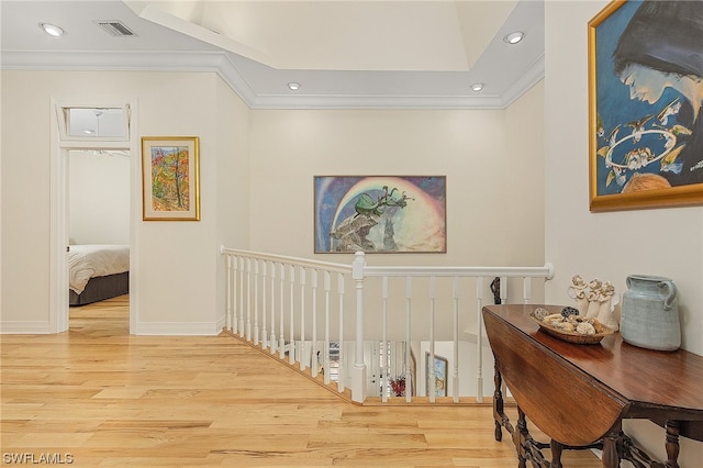 hall featuring ornamental molding and light hardwood / wood-style floors