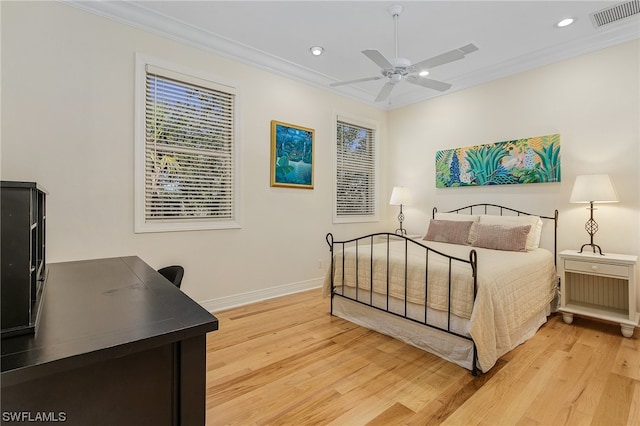 bedroom with ornamental molding, light hardwood / wood-style floors, and ceiling fan