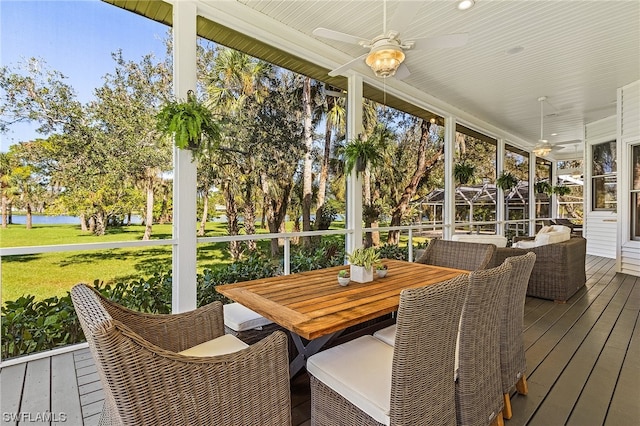 sunroom / solarium featuring ceiling fan