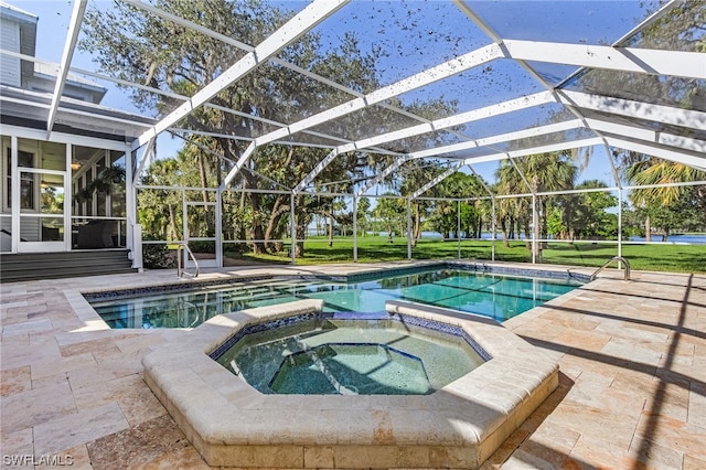 view of pool featuring an in ground hot tub, a lanai, and a patio