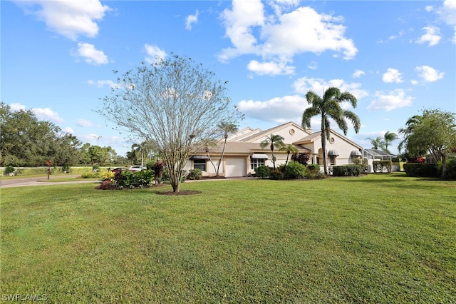 view of front of house with a front yard and a garage