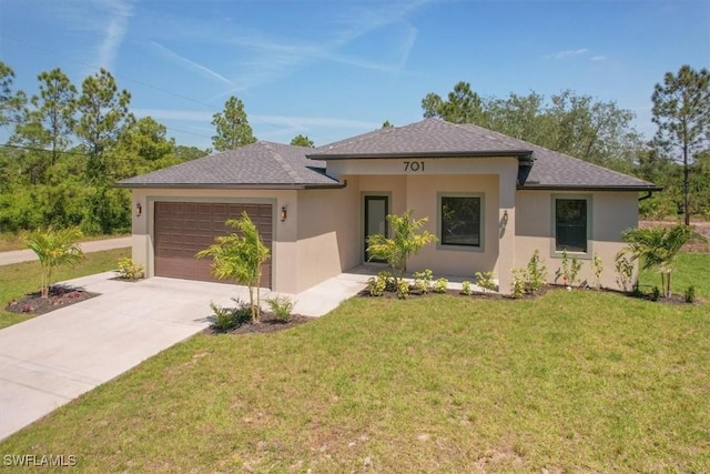 view of front of property with a front yard and a garage