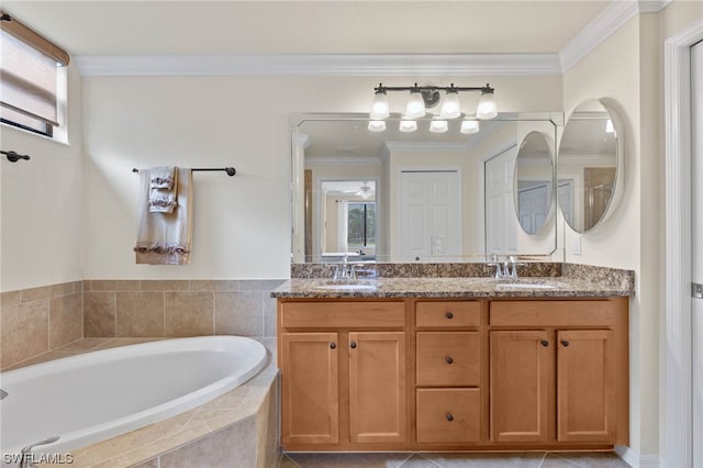 bathroom featuring vanity, tiled tub, and crown molding