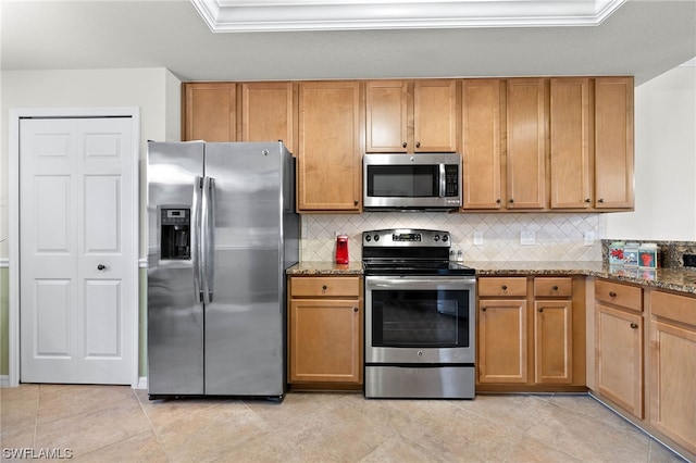 kitchen with tasteful backsplash, stainless steel appliances, stone countertops, and light tile patterned flooring