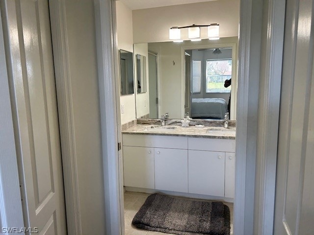 bathroom featuring vanity with extensive cabinet space and dual sinks