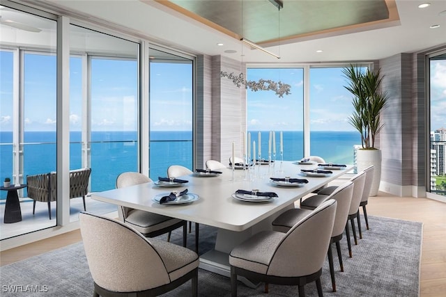 4101 Gulf Shore Blvd N Unit Ph-3, Naples, FL 34103 - dining area featuring a raised ceiling, recessed lighting, a water view, and wood finished floors