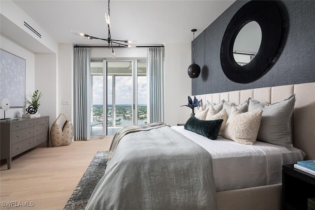 4101 Gulf Shore Blvd N Unit Ph-3, Naples, FL 34103 - bedroom with an inviting chandelier, access to outside, and light wood finished floors