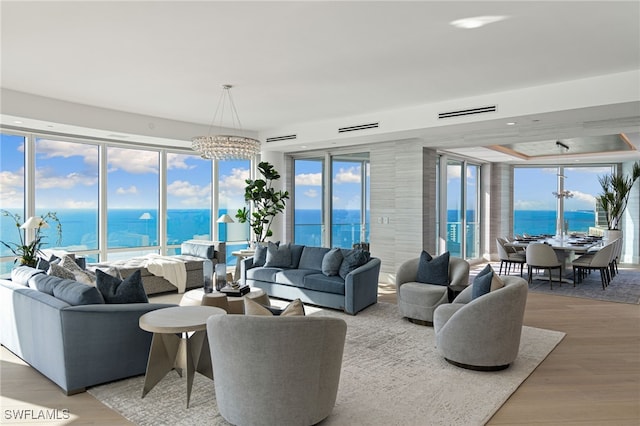 4101 Gulf Shore Blvd N Unit Ph-3, Naples, FL 34103 - living area with a water view, wood finished floors, and an inviting chandelier