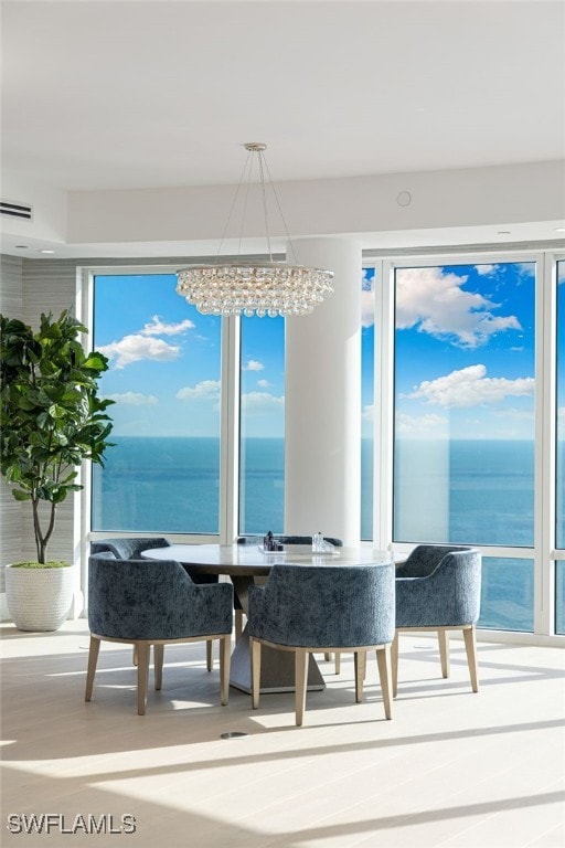 4101 Gulf Shore Blvd N Unit Ph-3, Naples, FL 34103 - dining area featuring a wealth of natural light, visible vents, a water view, and a chandelier