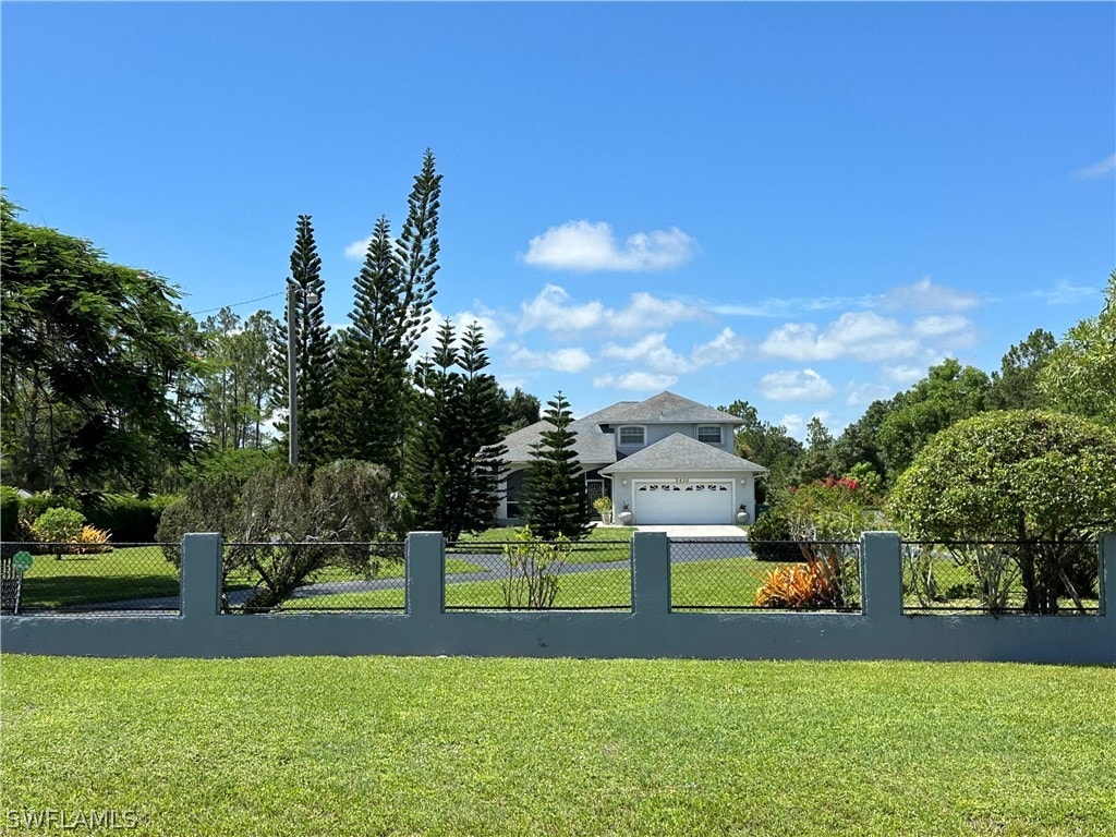 view of front of property featuring a garage and a front lawn